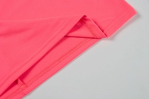 Detail of neon pink bodycon dress showing high-quality double-needle stitching and fabric