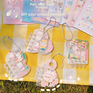 Detail of four DIY acrylic pendant booklets with cute cartoon bear and rabbit stickers