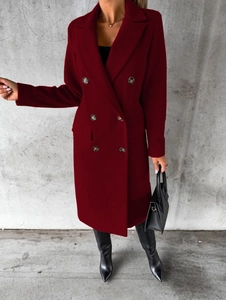 Detailed view of red double-breasted coat featuring premium dark buttons and fabric texture