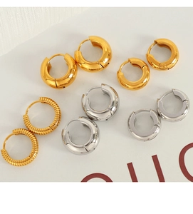 Detailed set of minimalist gold and silver hoop earrings with smooth and ribbed textures
