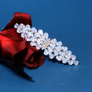 Detailed view of luxury zirconia hair clip with pear-cut crystals on velvet rose background