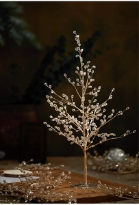 Detailed macro shot of golden wire Christmas tree with clear crystal bead branches