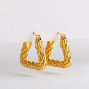 Detail shot of 18K gold-plated geometric triangle hoop earrings with twisted rope texture
