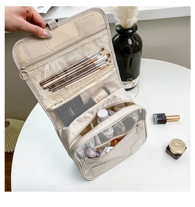 Beige hanging toiletry bag with multi-layer folding compartments and mesh pockets