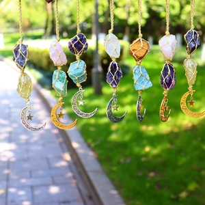 Detailed view of handmade crystal stone pendants with moon and star metal charms