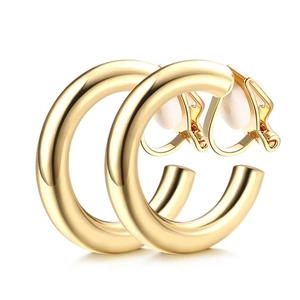 Detail of golden geometric C-shaped ear clips with comfortable white silicone pads