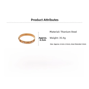 Detail view of gold titanium steel bangle with pearl shell clover and star design details