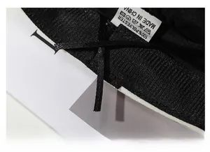 Detail view of the black polyester inner lining with an adjustable drawstring and care label