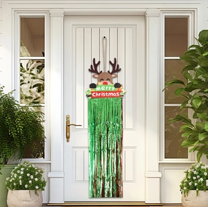 Detail of Christmas reindeer door sign with green tinsel fringe on a white front door