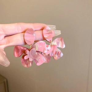 Close-up of pink marble texture resin flower earrings with artistic layered petals