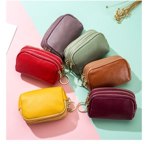 Close-up of litchi grain cowhide coin purses with multi-layer zippers and metal hooks