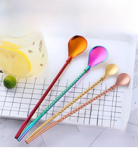 Detailed view of four stainless steel straw spoons with colorful metallic finishes