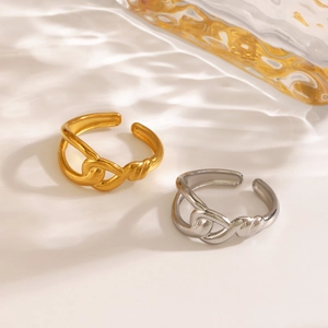 Minimalist interlocking gold and silver stainless steel rings with water ripple shadows
