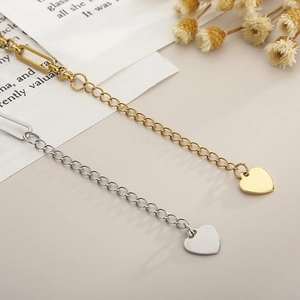 Detail of minimalist gold and silver heart pendant necklaces on vintage paper