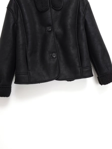 Detail of faux suede jacket hem and cuffs featuring soft fur lining and side pockets
