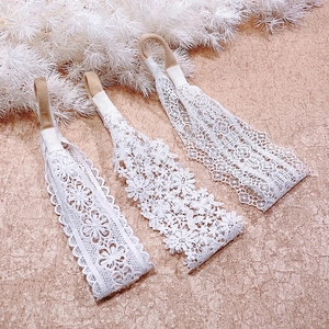 Detailed view of white floral lace headbands with high elasticity nylon bands for baby girls