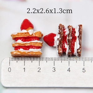 Resin strawberry cake miniature food model measuring 2.2x2.6x1.3cm with a wooden ruler