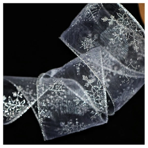 Detail of silver translucent chiffon ribbon with sparkling snowflake prints for Christmas