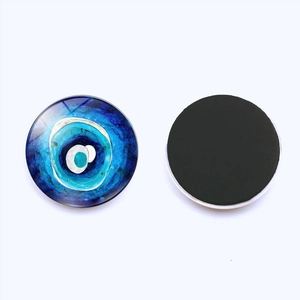 Detailed view of 25mm Evil Eye glass fridge magnet with magnetic back on white background