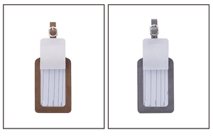 Close-up of brown and grey PU leather luggage tags with silver buckles and ID cards