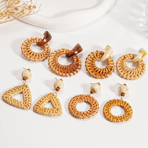 Bohemian rattan and resin geometric earrings in natural earth tones for a resort style look
