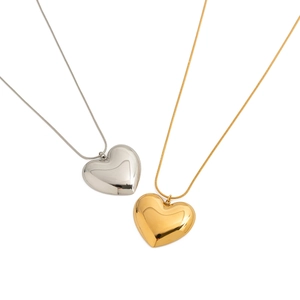 Elegant gold and silver titanium steel heart necklaces with polished finish on white background