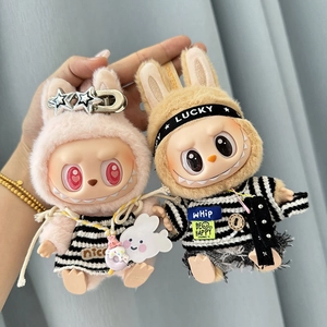 Detail of plush doll pendants in pink and brown with striped outfits and headbands