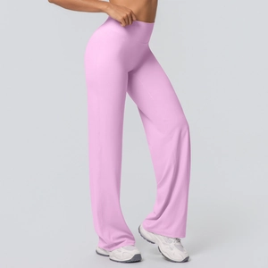 Detail of high-waisted flared yoga pants in soft pink with premium brushed fabric texture