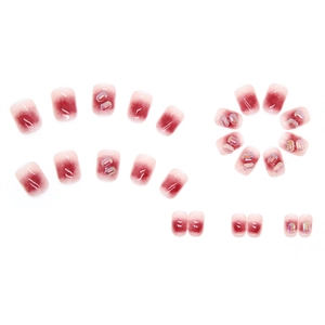 Short square press-on nails featuring red gradient blush effect and shiny crystal diamonds