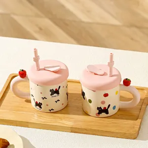 Cute ceramic black cat mug set with pink lids and straws on a wooden tray