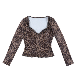 Close-up of leopard print fabric featuring heart-shaped neckline and ruffled edges