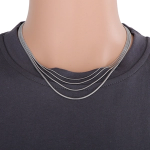 Detailed view of tiered silver snake chain necklace on a professional mannequin bust