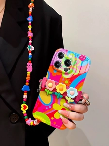 Close-up of floral iPhone case with 3D silicone flowers and beaded crossbody lanyard