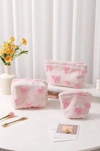 Three-piece set of pink plush makeup bags with 3D bows and silver zipper details