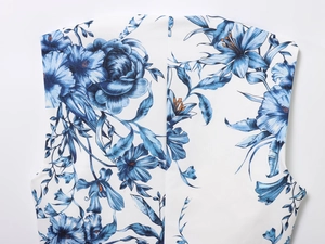 Close-up of elegant blue and white floral print on woven fabric short top and skirt