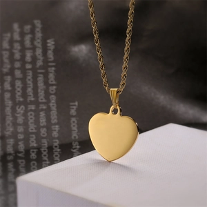 Close-up of a gold heart pendant with a polished rope chain on a clean display