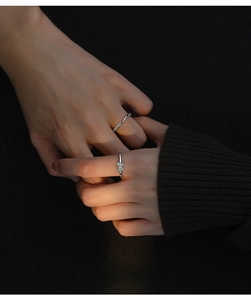 Close-up of S925 sterling silver couple rings with luminous butterfly and twisted band