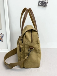 Khaki canvas messenger bag for men with brown leather handle and shoulder strap
