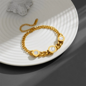 Gold-plated titanium steel bracelet with white shell inlays and Roman numeral engravings