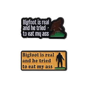 Funny Bigfoot enamel pins set with humorous text on black and yellow metal base