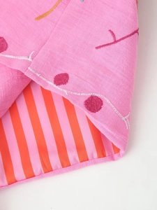 Detail of pink embroidered fabric with striped lining and high-quality stitching
