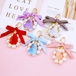 Cute pearl ribbon bow and tassel metal keychains in various colors for women's bags