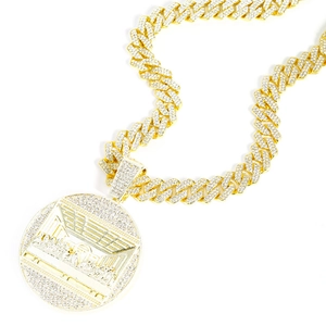 Macro shot of gold hip hop necklace featuring Last Supper pendant and iced out stones