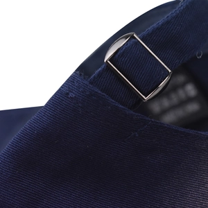 Macro view of adjustable silver metal buckle and navy denim fabric on baseball cap