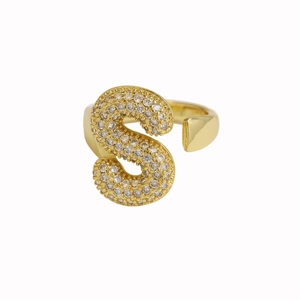 Macro detail of 18k gold plated letter S ring featuring pavé set sparkling zircon stones