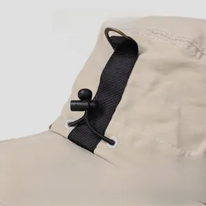 Macro shot of khaki nylon fisherman hat featuring adjustable drawstring and webbing details