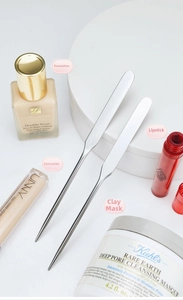 Macro detail of stainless steel makeup spatula for foundation mixing and blending