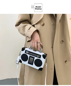 Detail of creative vintage boombox crossbody bag in white leather on a model