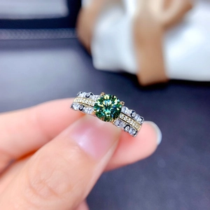 Macro view of a large green gemstone ring with triple-row pavé diamond band setting