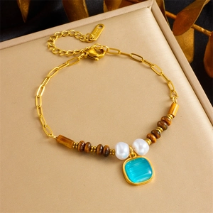 Gold stainless steel bracelet with tiger eye beads and blue gemstone heart pendant